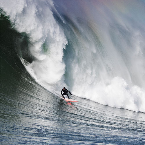 Person surfing big wave