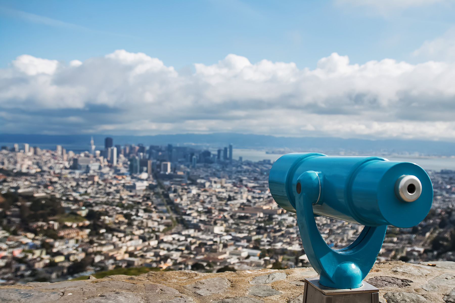 Overlook of a city with a mounted telescope on wall