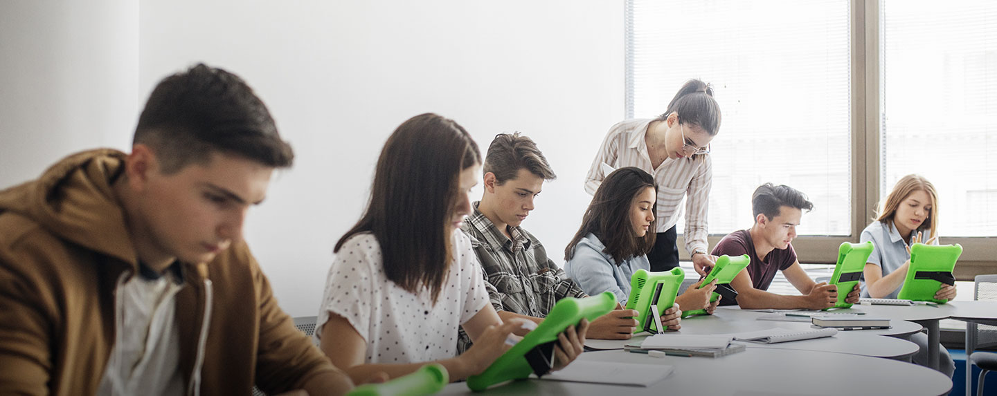 Students at table using green tablets