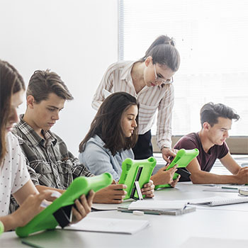 Students at table using green tablets