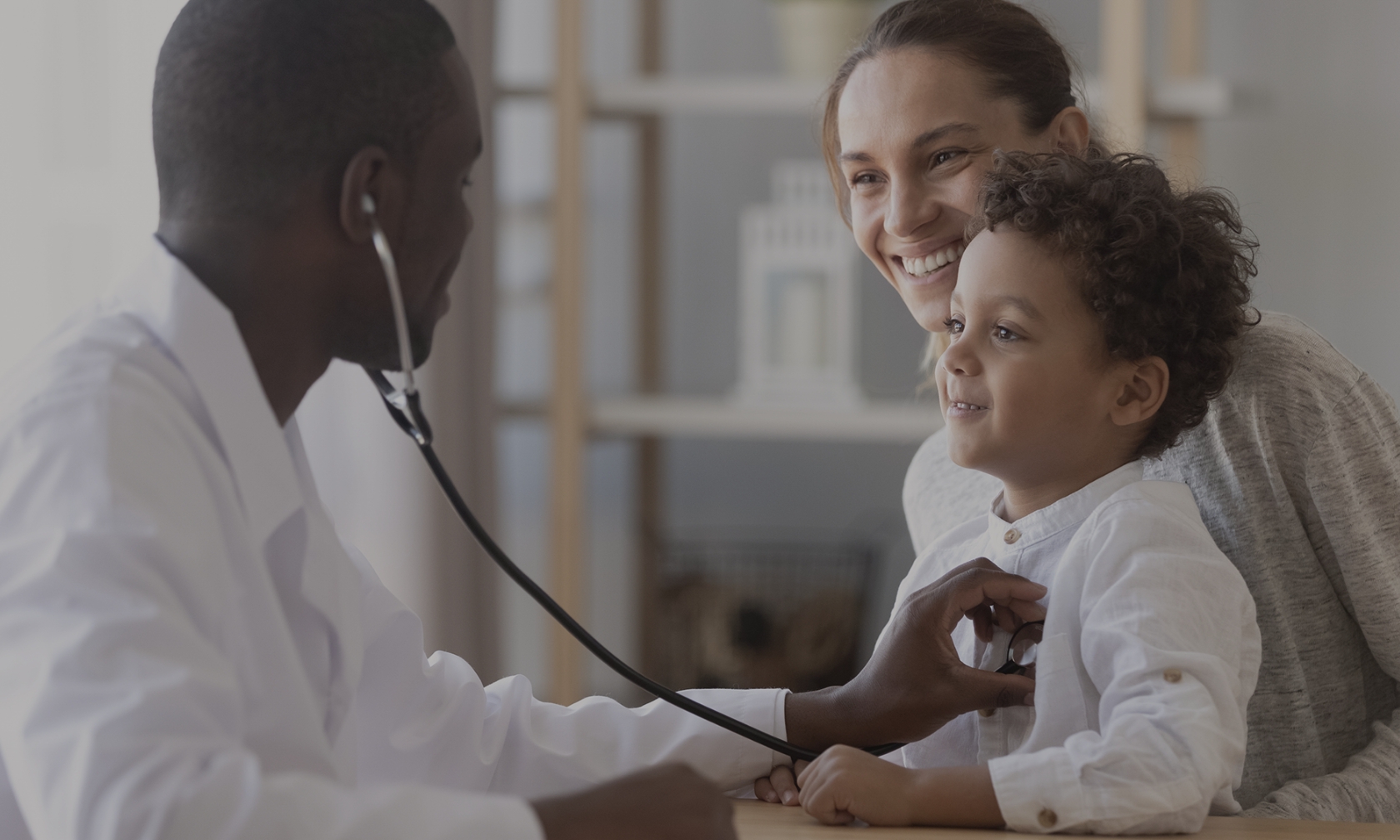 A doctor checks a child's heartbeat