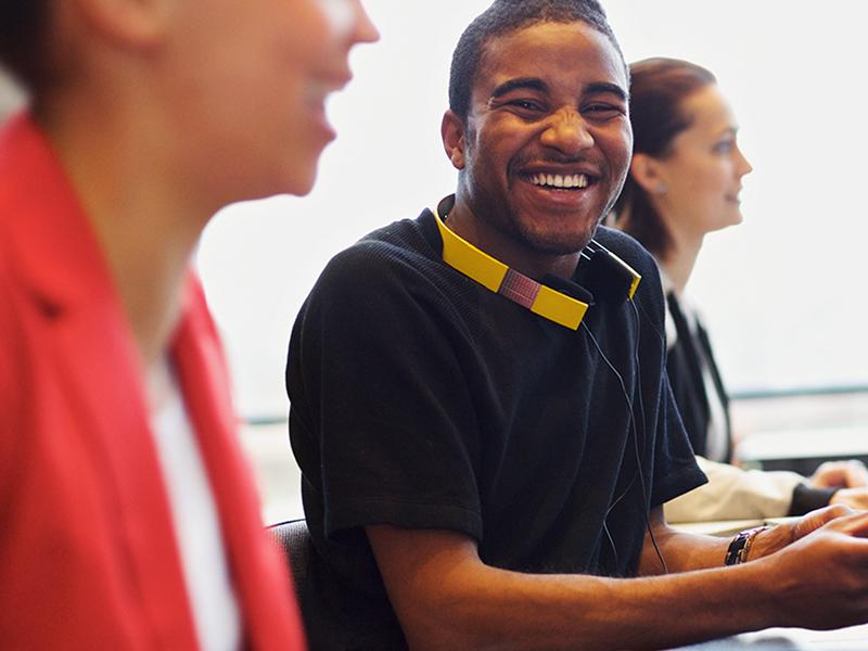 Happy people at work on a computer